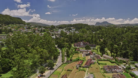 Nuwara-Eliya-Sri-Lanka-Aerial-v1-drone-fly-along-A5-PBC-highway-towards-city-center-capturing-British-mansion-President's-house,-golf-course-and-hillside-views---Shot-with-Mavic-3-Cine---April-2023