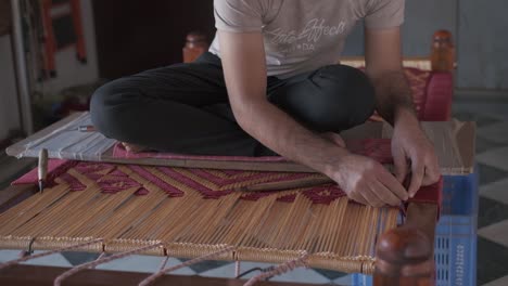 An-Indian-craftsman-is-working-on-making-a-bed-using-the-ancient-method-of-handicraft