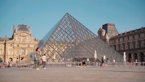 The-Louvre-Museum-Exterior-in-Paris,-Bustling-with-Tourists,-Iconic-Architecture,-and-Rich-Cultural-Experience