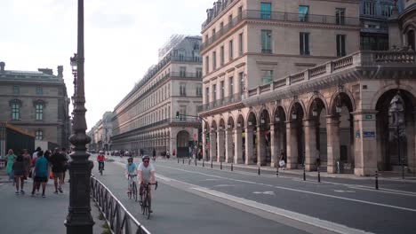 Cyclists-Group-Riding-on-Paris-Streets,-Touring-Urban-Scenery,-Exercise-and-Tourism-Experience-in-France's-Capital