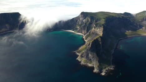 Wide-rotating-drone-footage-of-a-rocky-coastline-in-Vaeroy,-Lofoten-Islands-in-Norway