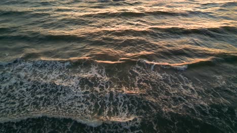 Tropical-golden-sunset-over-ocean-water-slow-motion-aerial-view