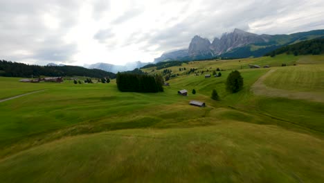 Fast-reveal-following-the-road-of-Alpe-di-Siusi,-Seiser-Alm-meadows-at-sunrise-in-the-Dolomites-mountains,-Italian-Alps