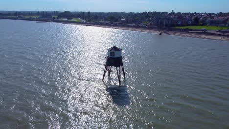 Revealing-Aerial-View-of-Dovercourt-Range-Rear-Lighthouse-On-Stilts-in-the-Sea
