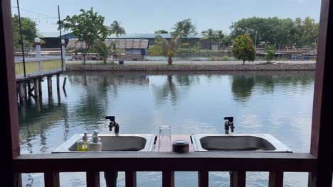 Dolly-in-shot-view-of-an-open-air-hand-washing-basin-overlooking-the-water-in-Batam,-Indonesia