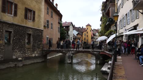 People-on-Canal-Bridge-in-Touristic-France-City-of-Old-Town,-Annecy