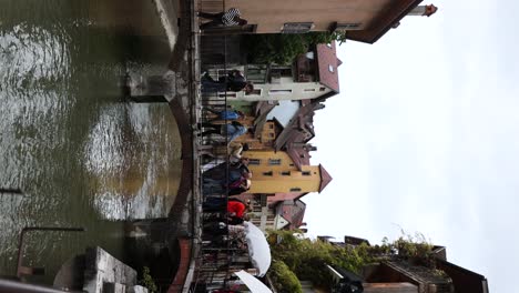 People-and-Tourists-on-Canal-Bridge-in-Old-Town,-Annecy---Tourist-Attraction-in-France,-Vertical