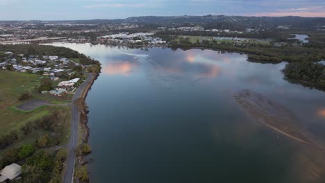 Reflection-of-the-Sky-on-the-Maroochy-River-in-Queensland,-Australia-Aerial-Pullback