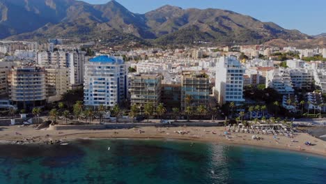 Drone-shot-paralleling-sideways,-filming-the-beach-in-Marbella,-Spain