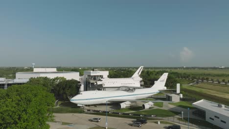 Aerial-drone-side-view-of-the-space-shuttle-Independence-and-Boeing-747-in-Independence-Plaza-at-Space-Center-Houston-in-Houston-Texas