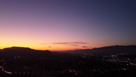 Drone-shot-silhouette-of-mountain-ranges-in-California-at-sunset
