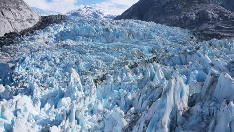 Flying-close-above-the-blue-ice-of-Dawes-Glacier,-Endicott-Arm-Fjord,-Inside-Passage,-Alaska