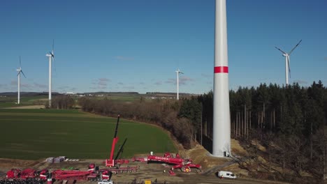 Aerial-View-Of-Wind-Turbine-Farm-Under-Construction---drone-ascending