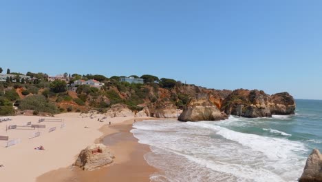 Aerial-pullback-reverse-dolly-above-sandy-beach-in-Algarve-Portugal
