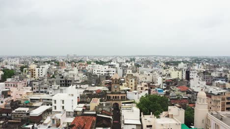 A-cinematic-aerial-view-of-Raya-Naka-Tower-showing-old-and-new-residential-buildings-all-around-the-tower,-the-main-gateway-to-the-city-during-the-British-era