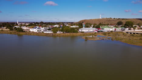 Drone-flight-over-full-capacity-dam-toward-historic-Beaufort-West-in-Great-Karoo