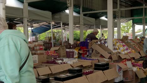 Slow-motion-pensioners-browsing-groceries-in-British-town-market-stalls-during-cost-of-living-crisis-inflation