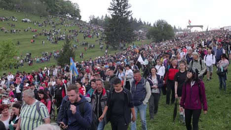 Uphill-view-of-Catholic-pilgrims-leaving-site-of-Csiksomlyo-Pilgrimage,-Romania