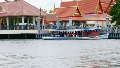 Boat-ship-ferry-transportation-send-receive-passenger-travelers-people-crossing-chao-phraya-river-between-Pak-kret-city-and-Ko-Kret-small-island-in-Thailand