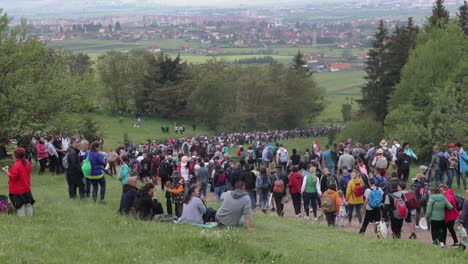Large-crowd-of-people-walking-down-hill-after-attending-Csiksomlyo-Pilgrimage