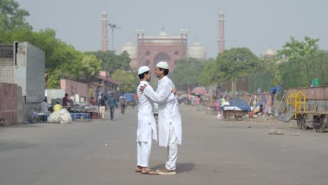 Two-Indian-muslim-men-hugging-each-other-on-Eid-festival-in-front-of-Jama-Masjid-Delhi