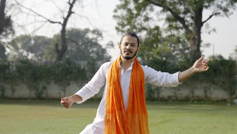Handsome-Indian-man-dancing-outdoor-in-traditional-wear