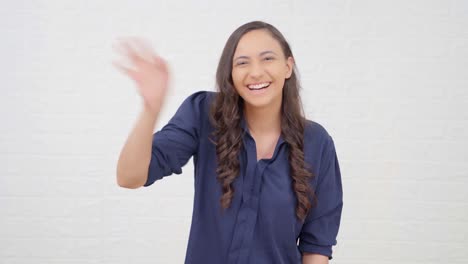 Indian-girl-waving-Hi-and-saying-hello
