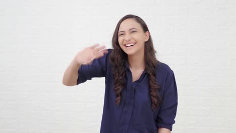 Indian-girl-waving-Hi-and-saying-hello