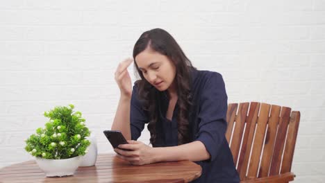 Disappointed-Indian-girl-using-phone