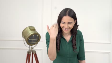 Indian-girl-pointing-and-calling-someone