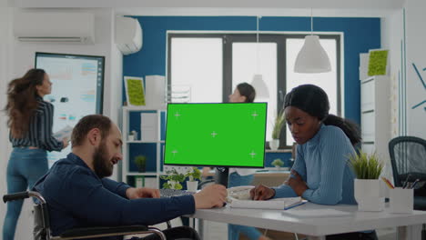 Diverse-team-working-together-with-financial-graphs-looking-at-green-screen