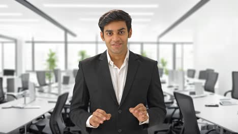 Happy-Indian-businessman-talking-in-meeting