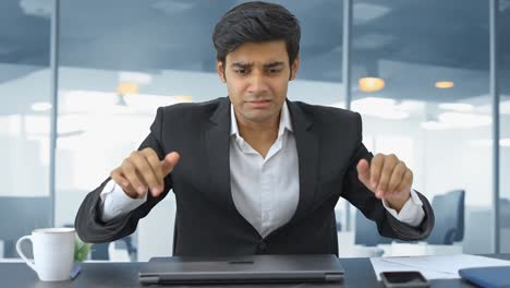 Angry-and-stressed-Indian-employee-closes-the-laptop