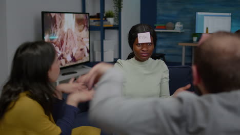 Multiethnic-friends-having-attaching-sticky-notes-on-forehead