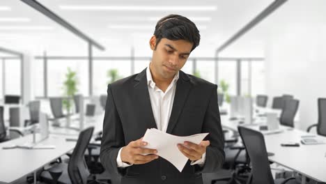 Focused-Indian-businessman-reading-contracts