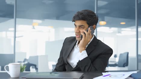 Indian-manager-talking-to-employee-on-phone