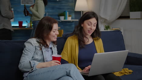 Multi-ethnic-women-enjoying-time-together-watching-at-movie-on-laptop