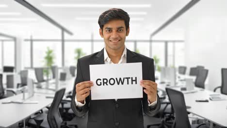 Happy-Indian-manager-holding-GROWTH-banner