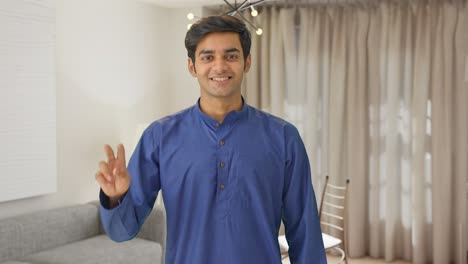 Happy-Indian-man-showing-victory-sign