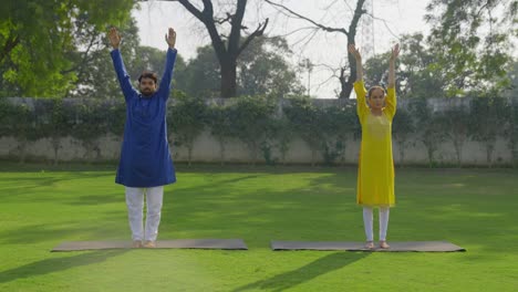 Indian-couple-doing-exercise-and-stretching-in-park