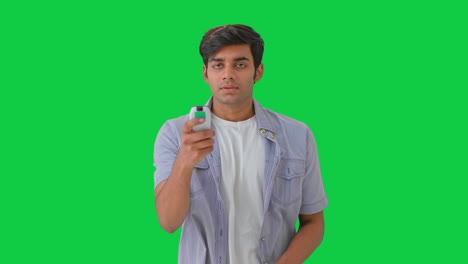 Indian-man-feeling-cold-and-switch-off-the-AC-Green-screen