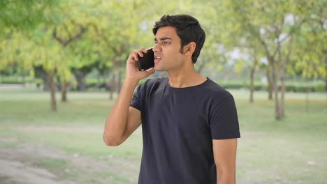 Angry-Indian-man-talking-to-someone-on-call