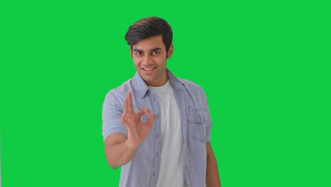 Happy-Indian-boy-showing-okay-sign-Green-screen