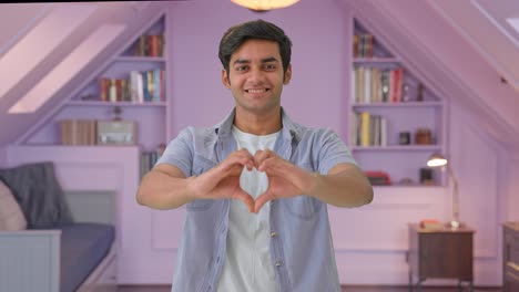 Cute-Indian-boy-showing-heart-sign