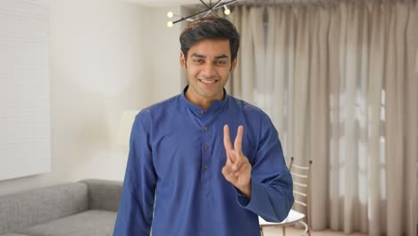Cute-Indian-boy-showing-victory-sign