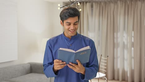 Happy-Indian-man-reading-a-book