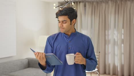 Indian-man-drinking-tea-and-reading-book