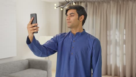 Indian-man-talking-on-video-call
