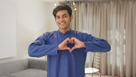 Cute-Indian-boy-showing-heart-sign