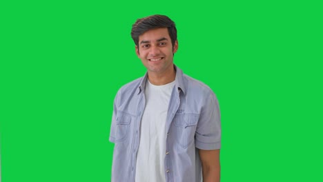 Cute-Indian-boy-giving-flying-kisses-Green-screen